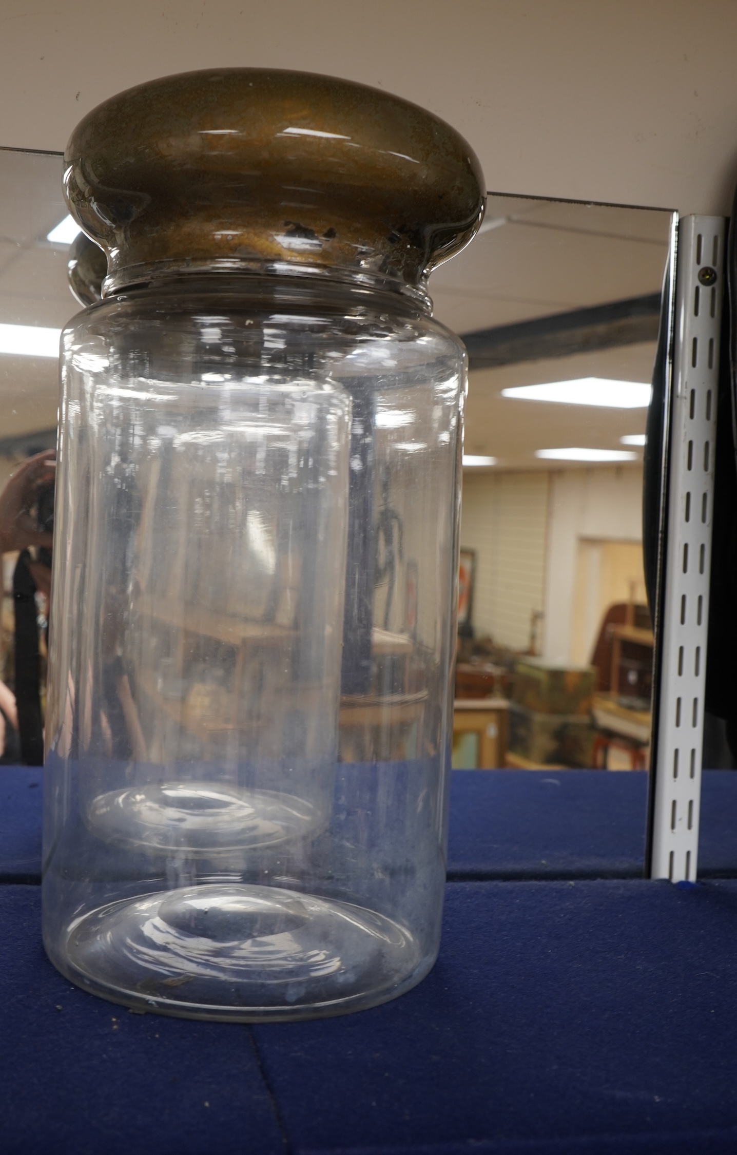 An 18th century cylindrical glass drug jar with remnants of gilding to the lid, 42cm high